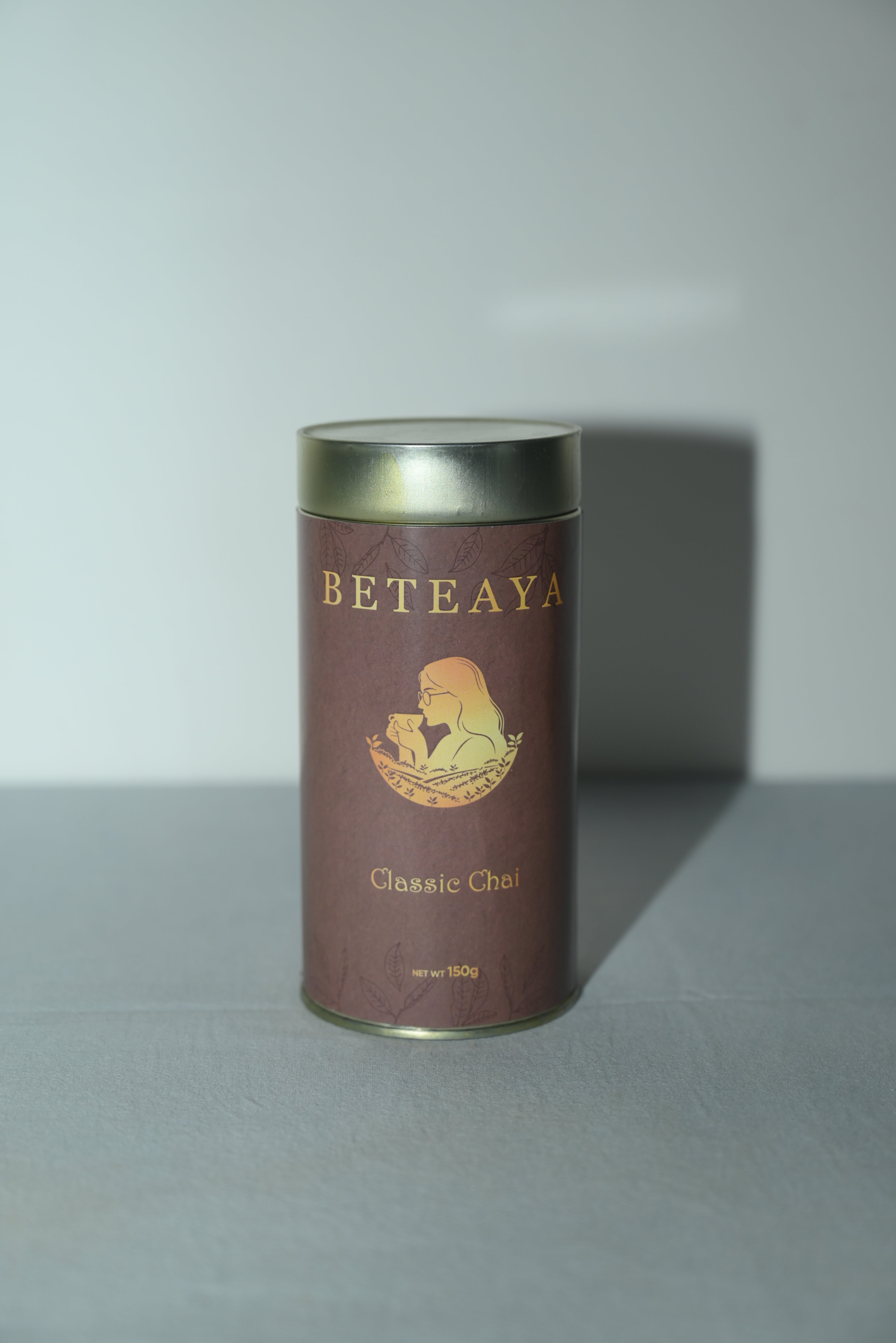 Brown cylindrical tea canister with 'Beteaya' branding on a white background- Best Assam Tea