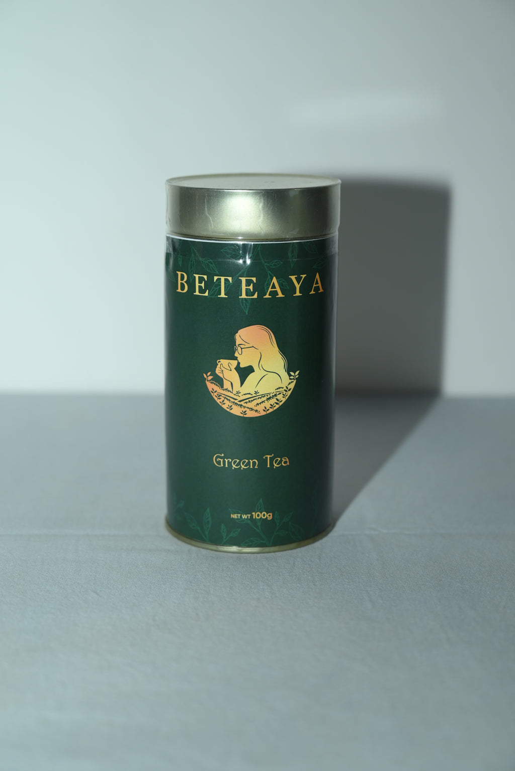 Green tea canister with 'Beteaya' branding on a light gray background