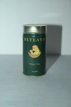 Green tea canister with 'Beteaya' branding on a light gray background